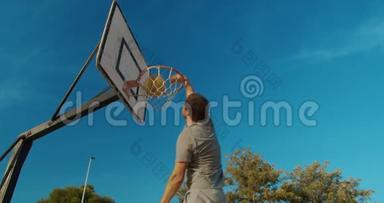 男<strong>篮球员</strong>在室外篮球场上灌篮。